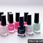 네일아트 재료 구매 꿀팁 - A neatly arranged beginner's nail art set on a clean white surface, including base coat, top coat, c...